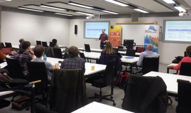 ESRC teachers' workshop participants sitting in classroom, listening to lecture