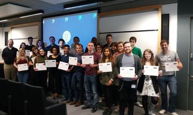 Summer Institute students posing for photo while holding their obtained certificates 