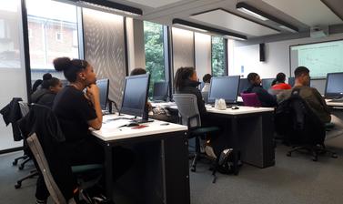 Group of Target Oxbridge participants sitting in computer lab room listening to presentation