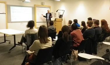 UNIQ participants sitting in classroom listening to lecture by Q-Step instructor on analysing Brexit data